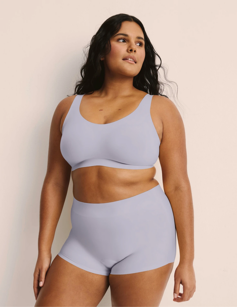 Full-body view of model wearing the Revolution Adjustable Pullover Bra, highlighting the neckline, strap design, and  silhouette