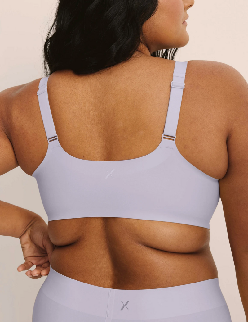 Back view of model wearing the Revolution Adjustable Pullover Bra, highlighting the neckline, strap design, and  silhouette
