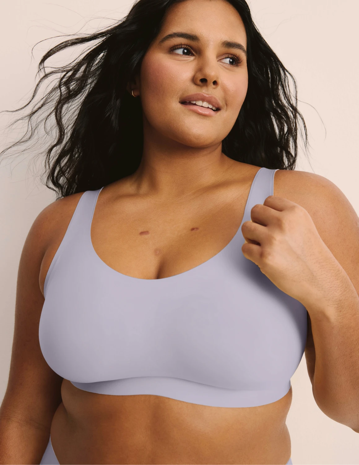 Adiya is a 36C and wearing KNIX L | Front view of model wearing the Revolution Adjustable Pullover Bra, highlighting the neckline, strap design, and  silhouette | Lavender