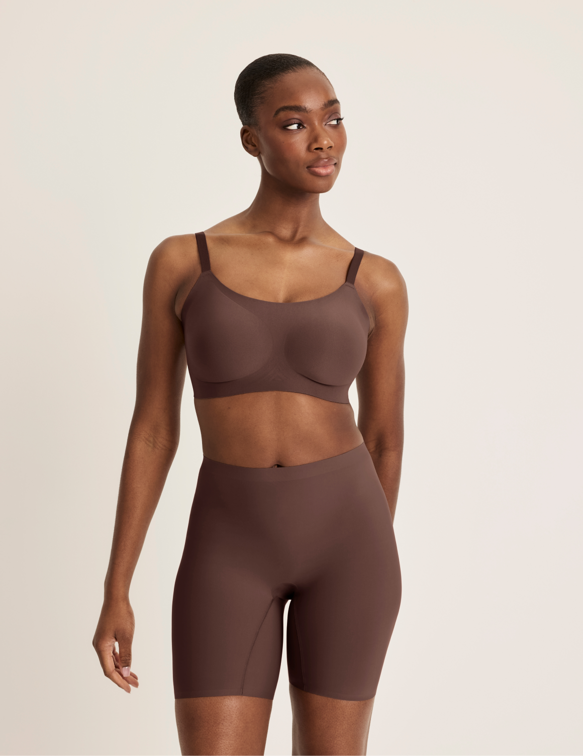 Orlane is wearing KNIX S | Full-body view of model wearing the Thigh Saver® 6” highlighting the coverage and smooth fit | Sable
