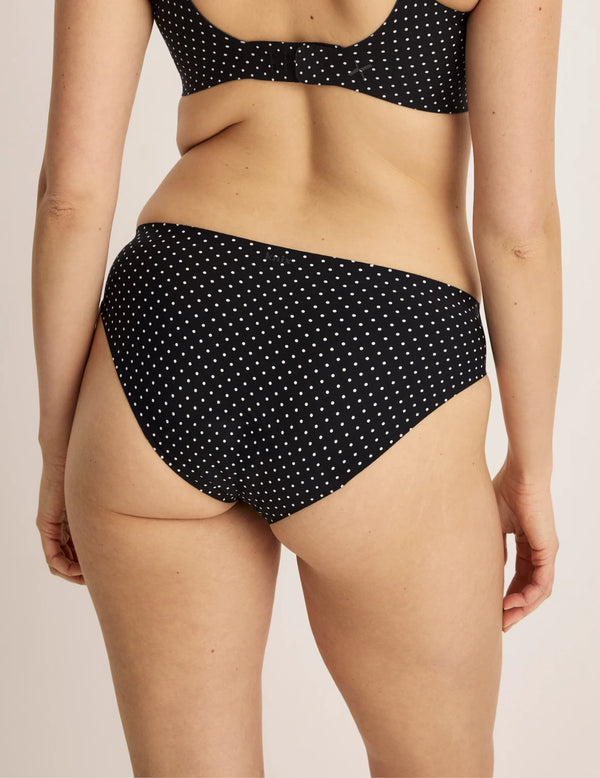 Sofia has 36.5” hips and wearing KNIX S | Back view of model wearing the Leakproof UltraThin No-Show Bikini highlighting the coverage and smooth fit | Black with White Polka Dot