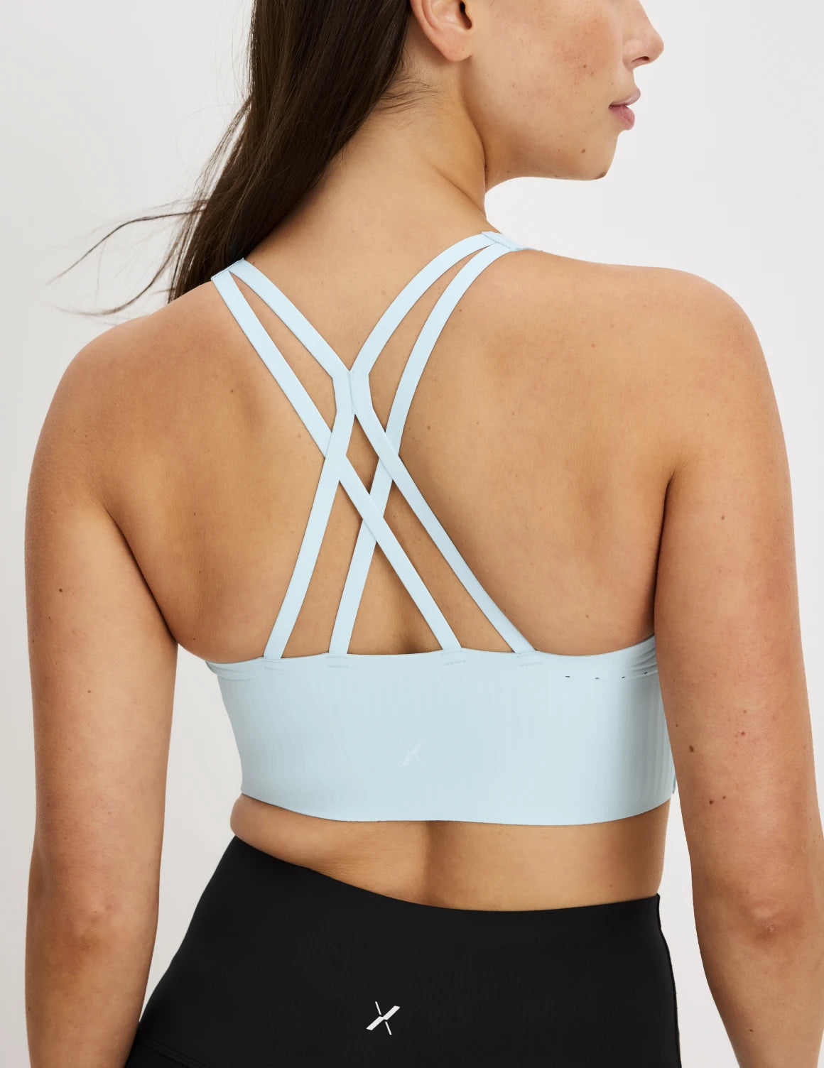  | Back view of model wearing the Longevity Sports Bra, highlighting the neckline, strap design, and silhouette | Blue Light
