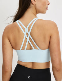 Back view of model wearing the Longevity Sports Bra, highlighting the neckline, strap design, and silhouette