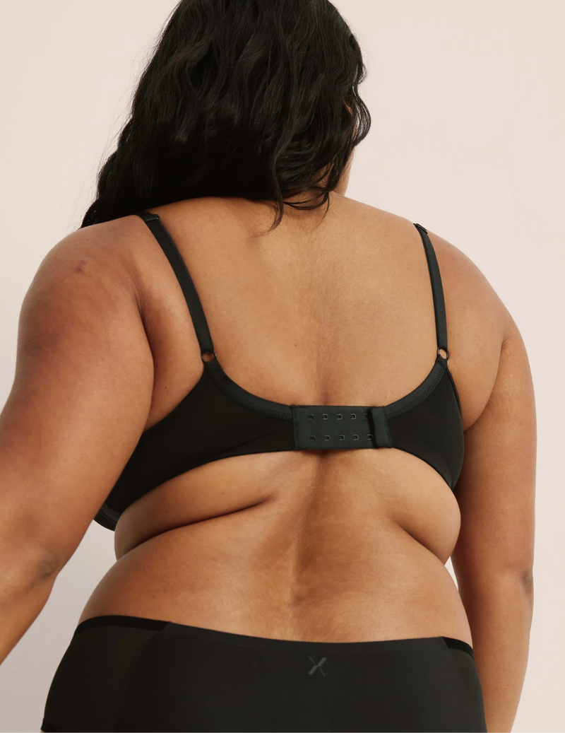 Back view of model wearing the Mesh Deep V Bra, highlighting the neckline, strap design, and smooth silhouette