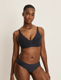 Full-body of model wearing the Revolution V-Neck Bra, highlighting the neckline, strap design, and smooth silhouette