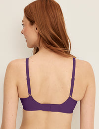 Back view of model wearing the Revolution V-Neck Bra, highlighting the neckline, strap design, and smooth silhouette