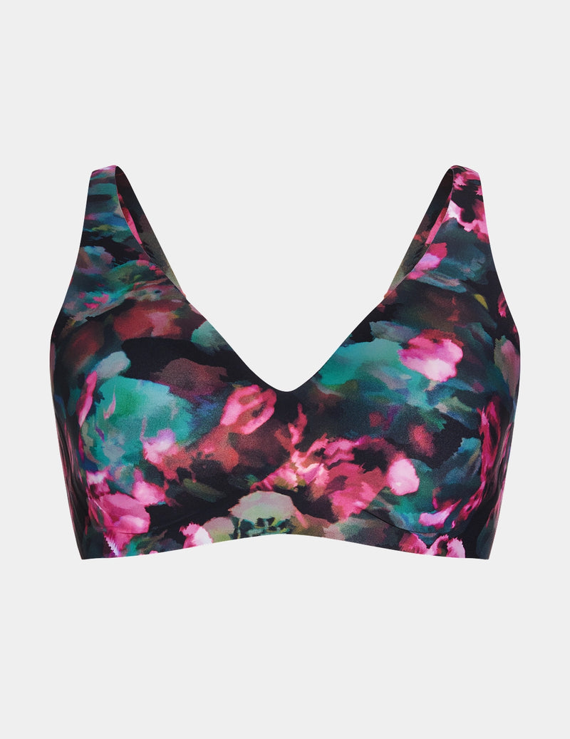 Wireless bra with a V-neckline, adjustable straps, and smooth molded cups, shown front-facing against a light gray background