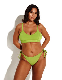 Maya is a 34DDD and wears a Knix size M+ | Chartreuse