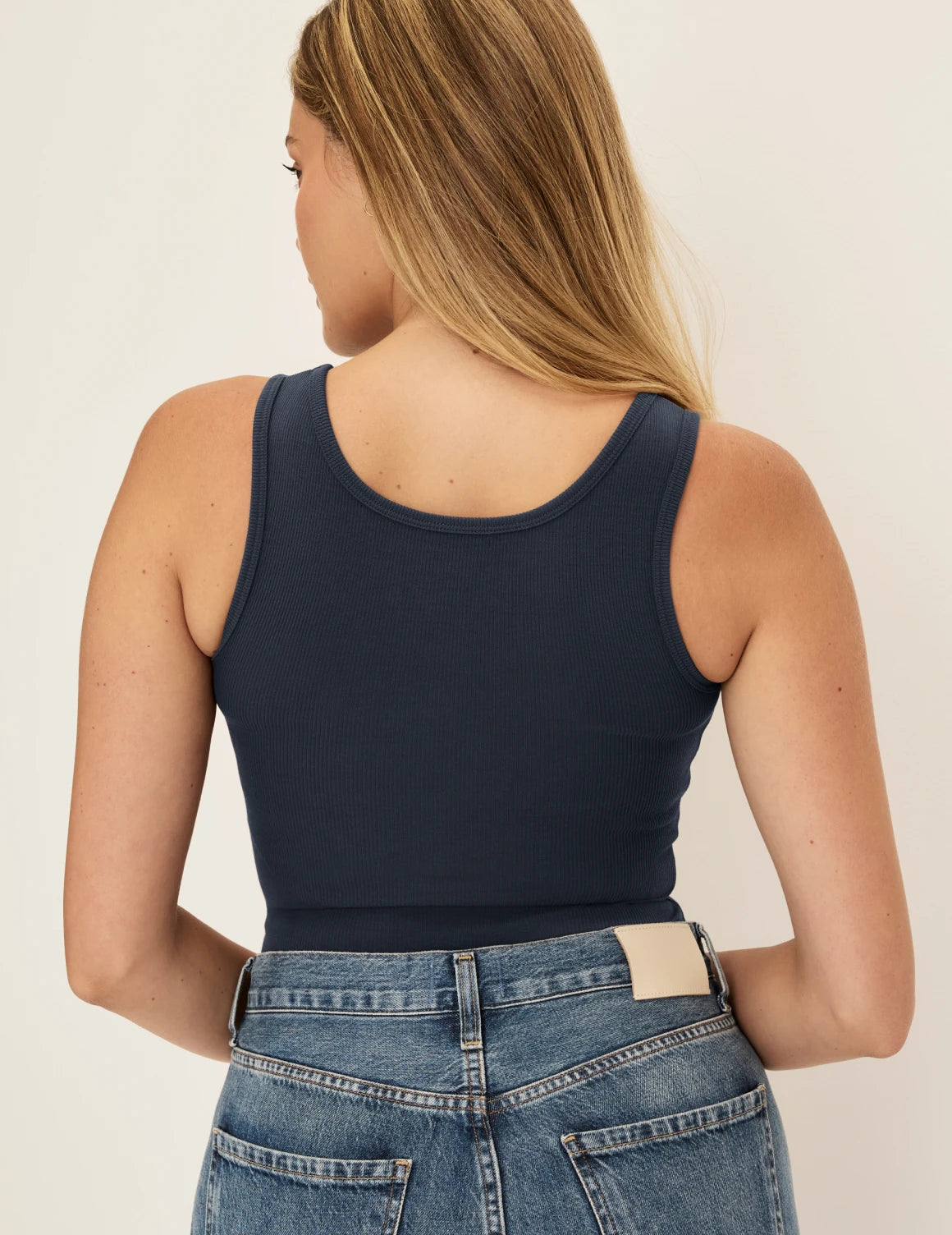 Sarah is a 34DD wearing KNIX M | Back view of model wearing the SculptRib™ Cotton Tank highlighting the neckline, fabric and hugging fit | Twilight Navy