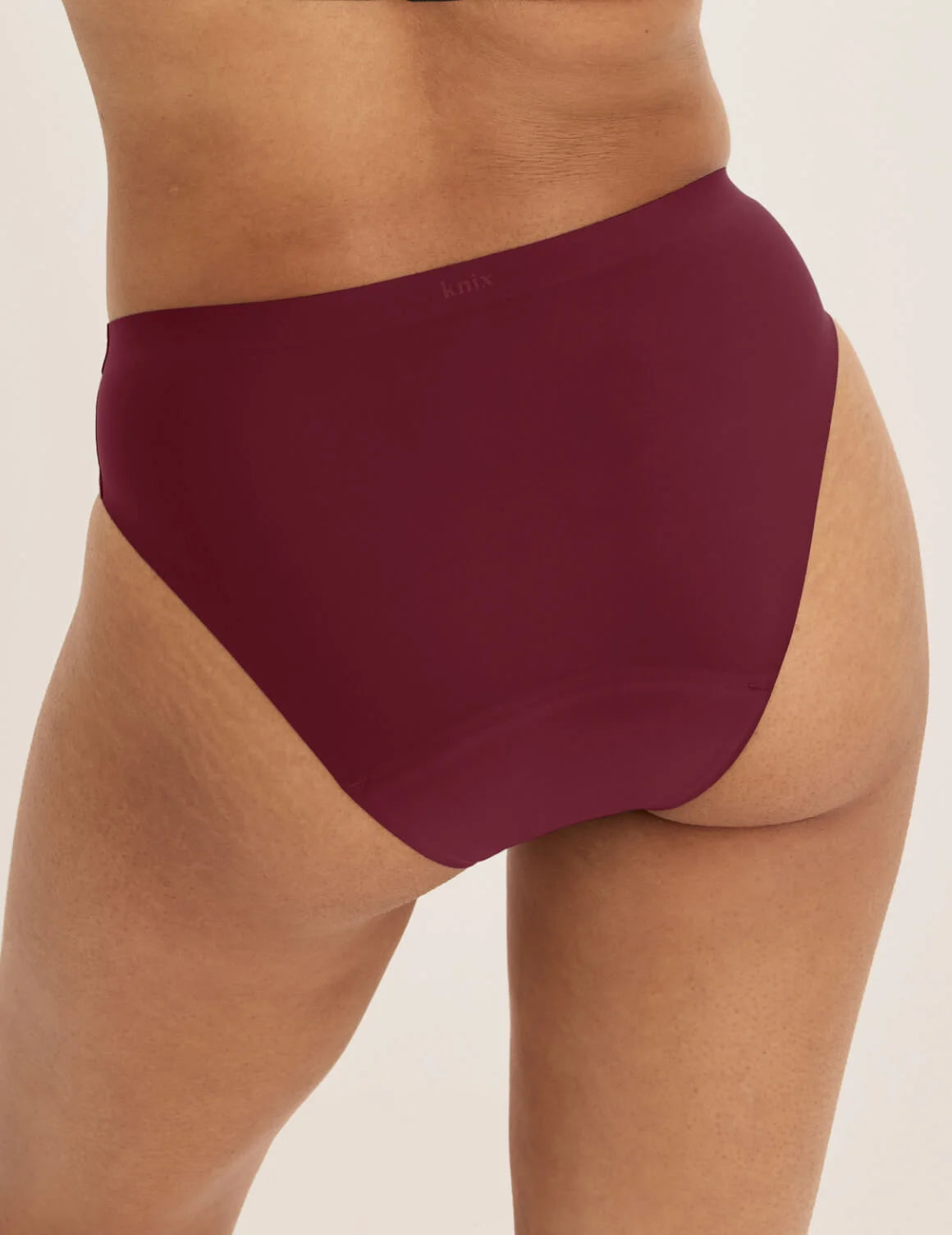 Ashley has 39” hips and wears KNIX S | Dark Cherry