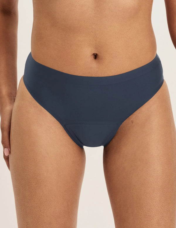 Ashley has 39” hips and wears KNIX S | Front view of model wearing the Leakproof UltraThin No-Show Bikini highlighting the coverage and smooth fit | Twilight Navy